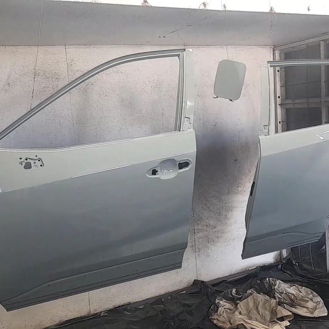 Car doors sanded in the paint booth