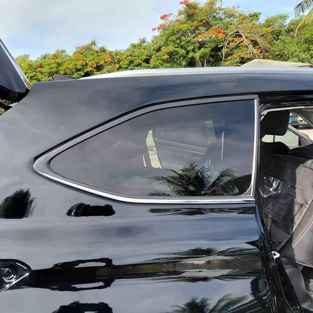 Black SUV quarter panel and glass